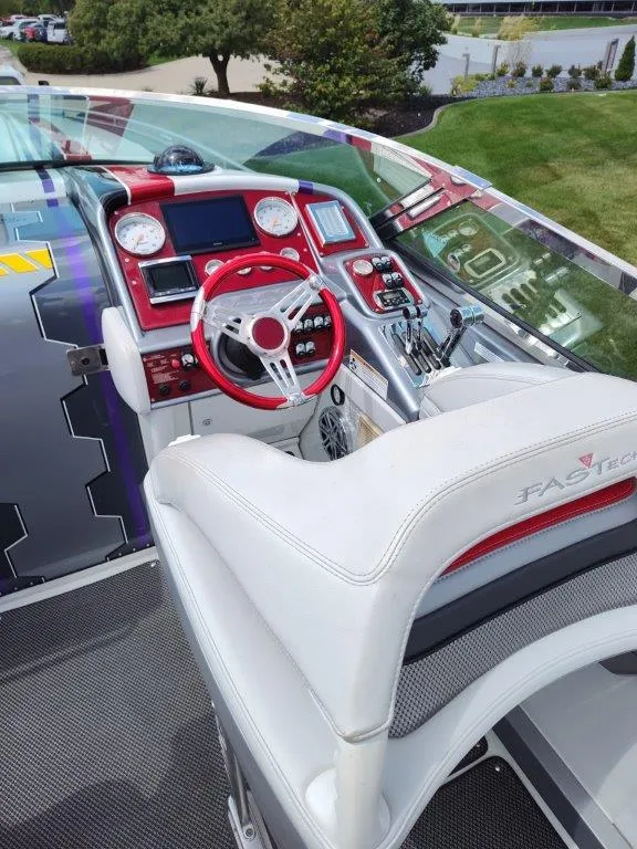 Slide: The Image of 2015 Formula 382 FASTech boat cockpit with red accents and modern controls. - 5