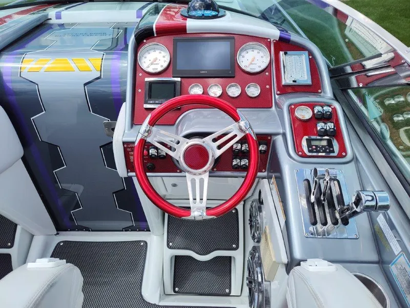 Slide: The Image of 2015 Formula 382 FASTech boat dashboard with red steering wheel and modern controls. - 6