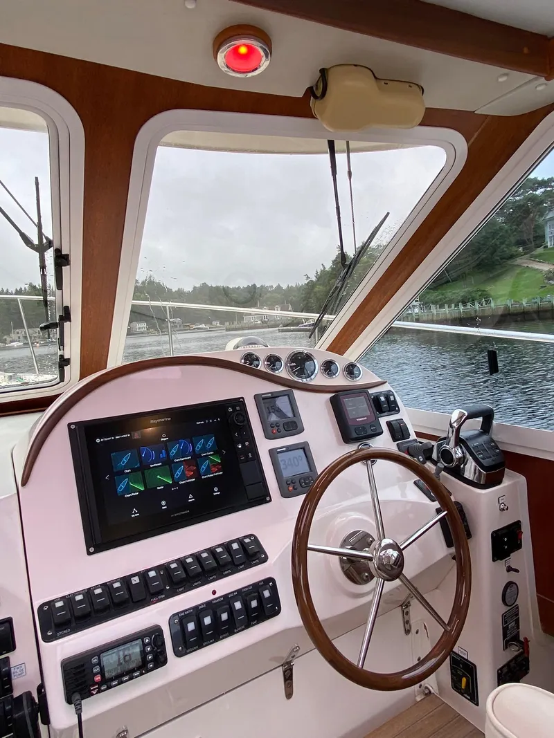 Slide: The Image of Helm of 2010 Pearson 38 True North boat with modern controls and scenic view. - 10