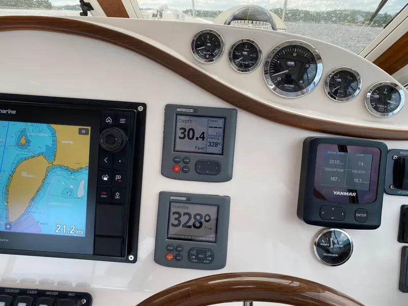 Slide: The Image of Control panel of 2010 Pearson 38 True North boat with navigation and engine displays. - 12