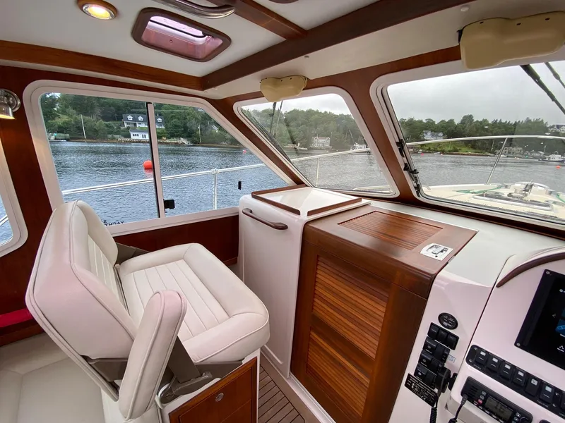 Slide: The Image of Interior of 2010 Pearson 38 True North boat with helm and scenic water view. - 14
