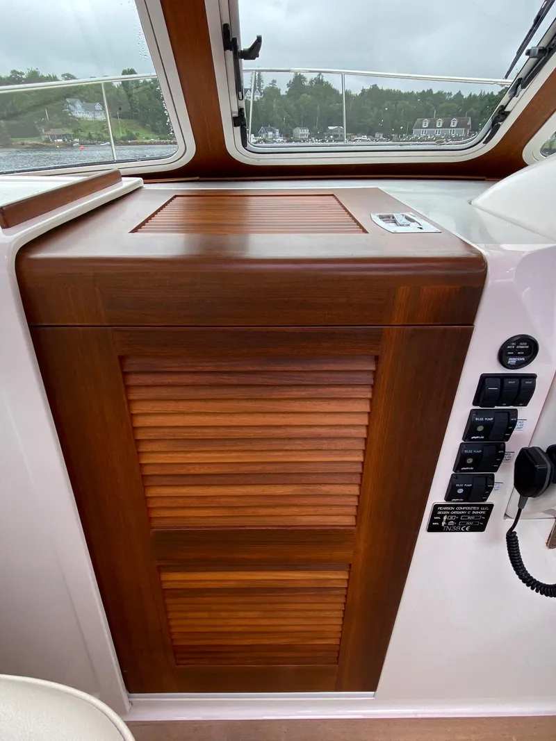 Slide: The Image of Wooden cabinet on 2010 Pearson 38 True North boat interior with control panel. - 18