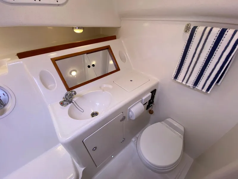 Slide: The Image of Bathroom interior of 2010 Pearson 38 True North yacht, featuring sink, toilet, and mirror. - 21