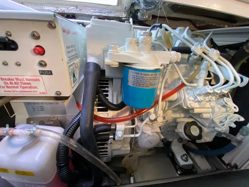 Slide: The Image of Engine compartment of a 2010 Pearson 38 True North boat, showcasing mechanical components and wiring. - 23