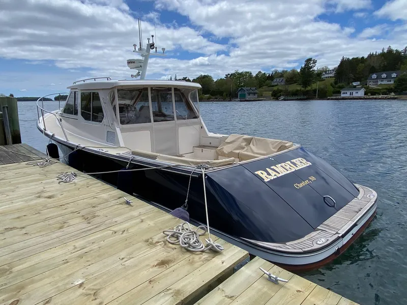 Slide: The Image of Pearson 38 True North 2010 boat docked by a wooden pier on a sunny day. - 31