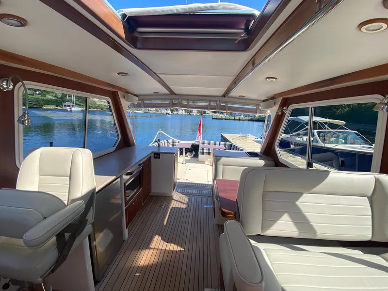 Slide: The Image of Interior of 2010 Pearson 38 True North yacht with elegant seating and scenic water view. - 5