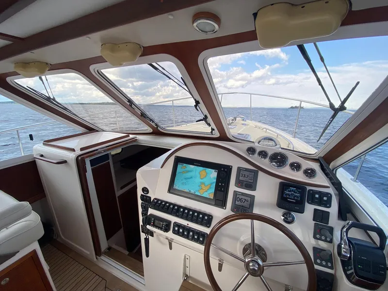 Slide: The Image of Helm of 2010 Pearson 38 True North yacht with navigation equipment and ocean view. - 9