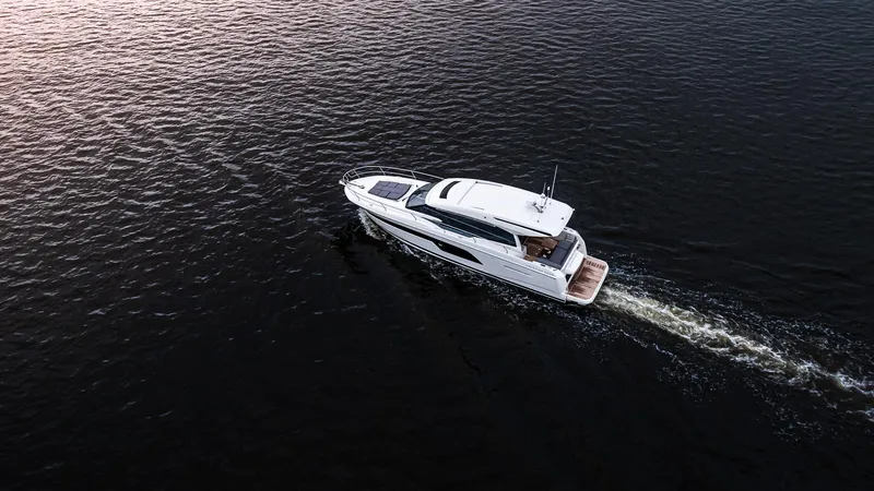 Slide: The Image of Aerial view of 2023 Prestige 520S yacht cruising on open water. - 3