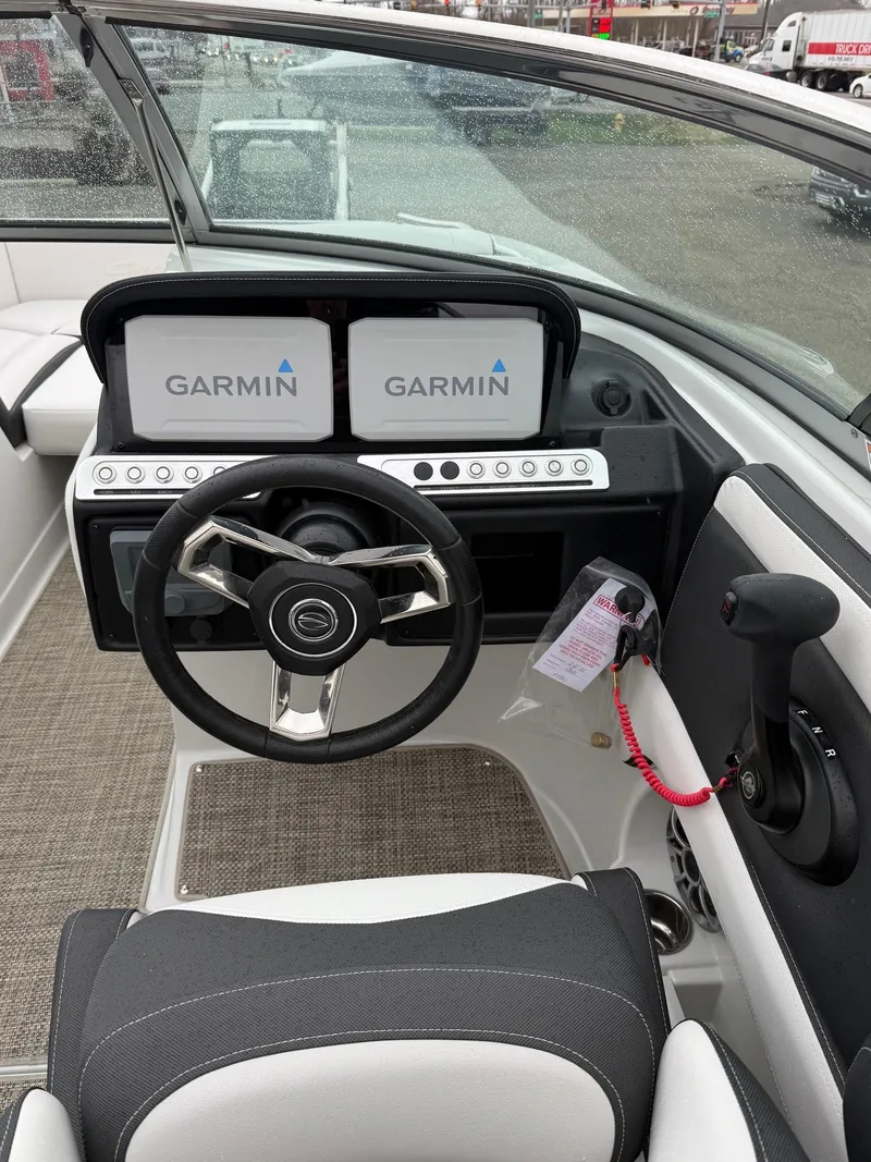 Slide: The Image of 2024 Crownline Eclipse E240 XS boat dashboard with Garmin displays. - 2