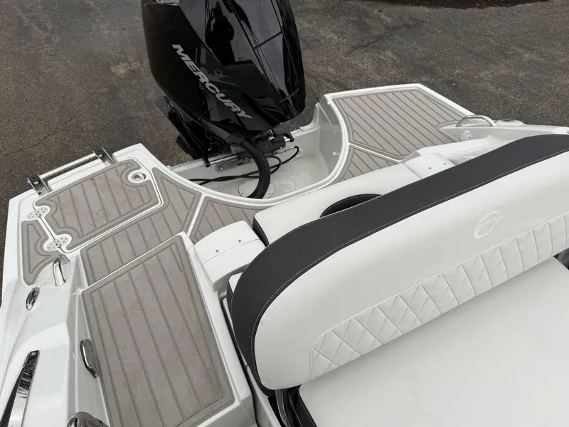 Slide: The Image of 2024 Crownline Eclipse E240 XS boat with Mercury outboard motor, featuring sleek seating and deck design. - 7