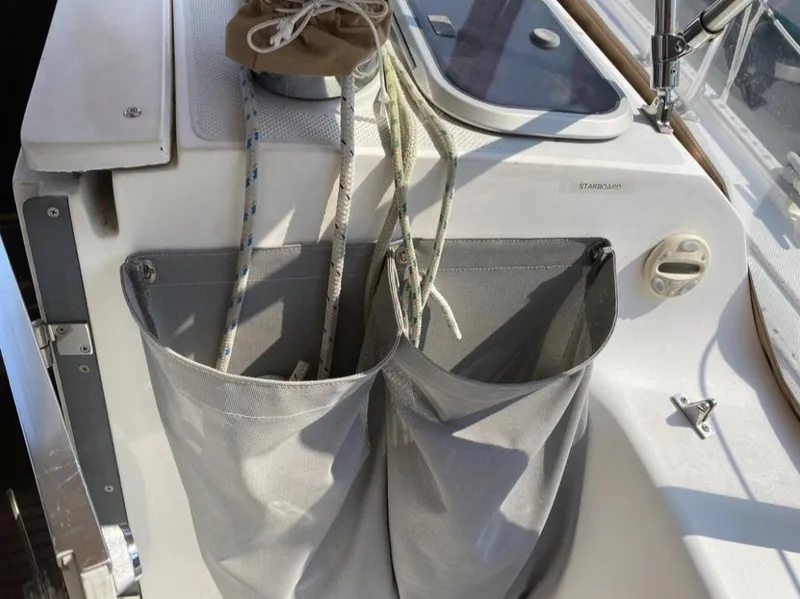 Slide: The Image of Sailboat cockpit storage on a 1995 Catalina 36 MkII with ropes and pouches. - 19