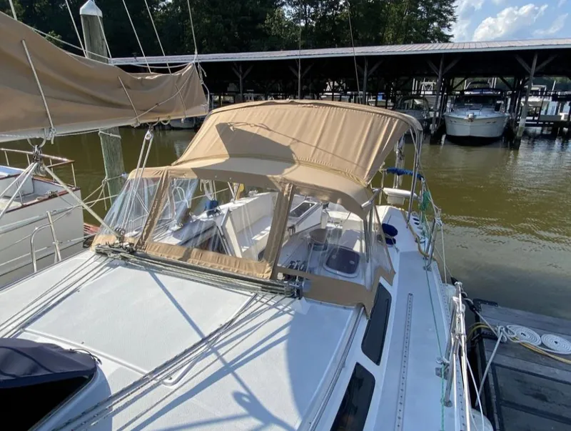 Slide: The Image of Sailboat Catalina 36 MkII 1995 docked with beige canopy, marina background. - 2