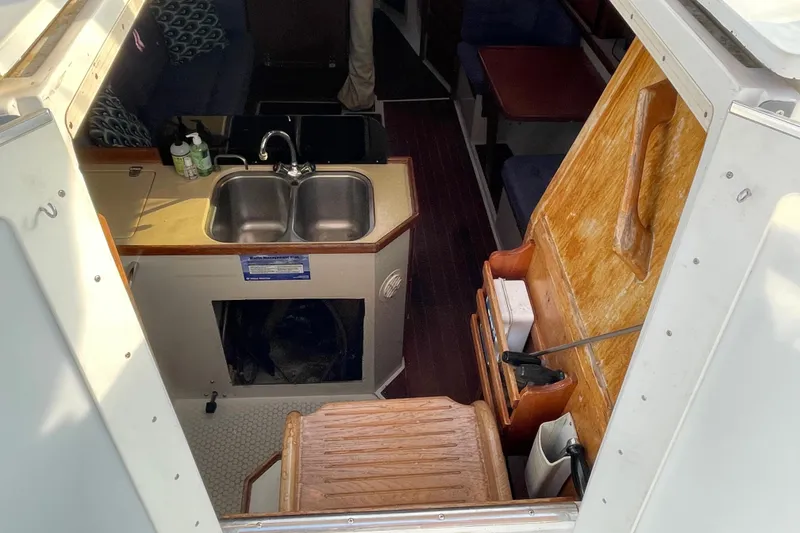 Slide: The Image of Interior view of a 1995 Catalina 36 MkII sailboat, featuring a compact kitchen area. - 20