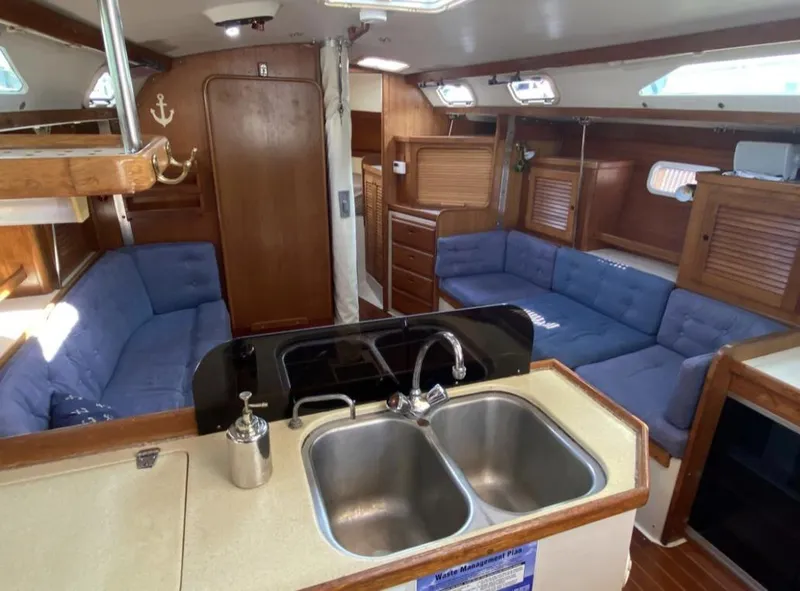 Slide: The Image of Interior of a 1995 Catalina 36 MkII sailboat with blue seating and wooden cabinetry. - 21