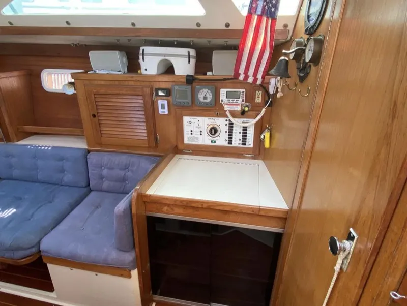 Slide: The Image of Interior of 1995 Catalina 36 MkII sailboat with navigation station and blue seating. - 22
