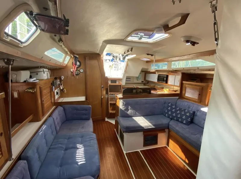 Slide: The Image of Interior of 1995 Catalina 36 MkII sailboat with blue seating and wooden accents. - 24
