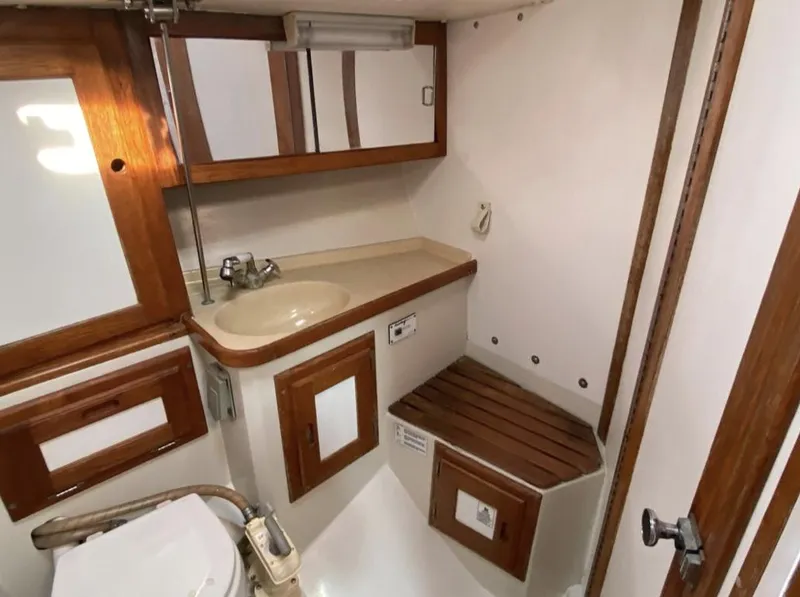 Slide: The Image of 1995 Catalina 36 MkII yacht bathroom with wooden accents and compact design. - 32