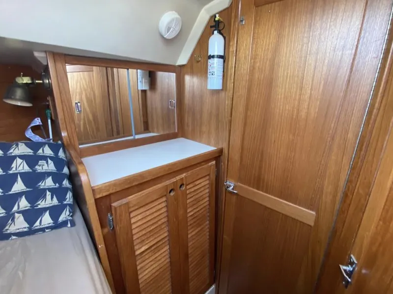 Slide: The Image of Interior of 1995 Catalina 36 MkII sailboat with wooden cabinetry and nautical-themed bedding. - 34