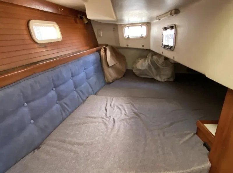Slide: The Image of Interior cabin of a 1995 Catalina 36 MkII sailboat with blue seating and wooden accents. - 37
