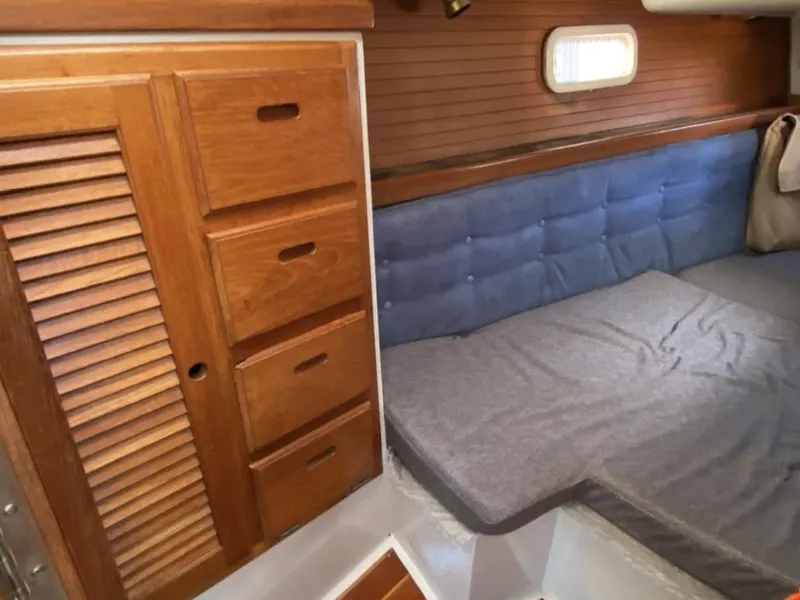 Slide: The Image of Cozy cabin interior of 1995 Catalina 36 MkII sailboat with wooden storage and cushioned seating. - 38