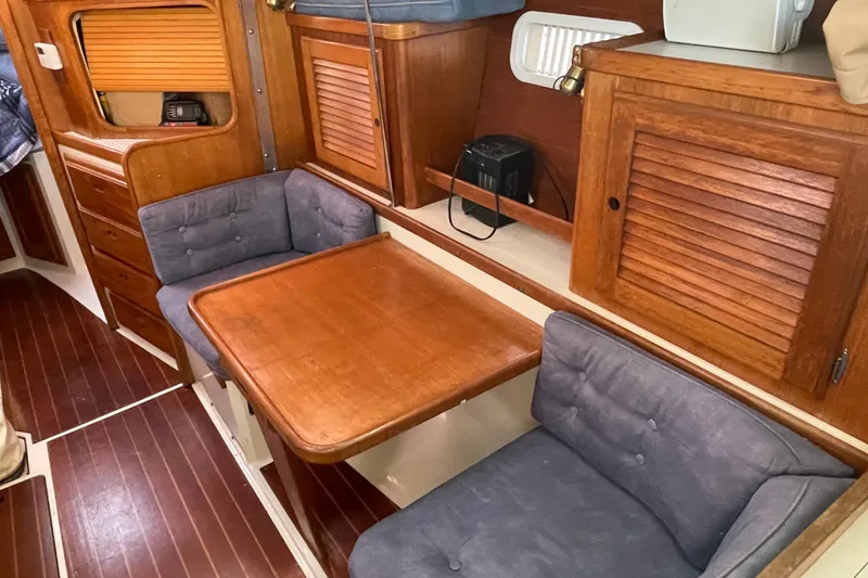 Slide: The Image of Cozy interior of 1995 Catalina 36 MkII sailboat with wooden table and cushioned seating. - 47