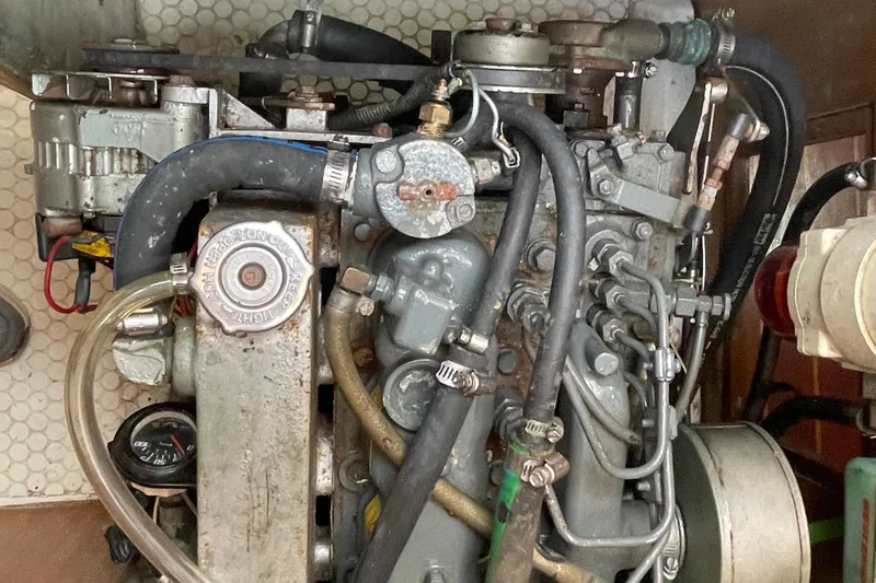 Slide: The Image of Engine of a 1995 Catalina 36 MkII sailboat, showcasing hoses and mechanical components. - 52