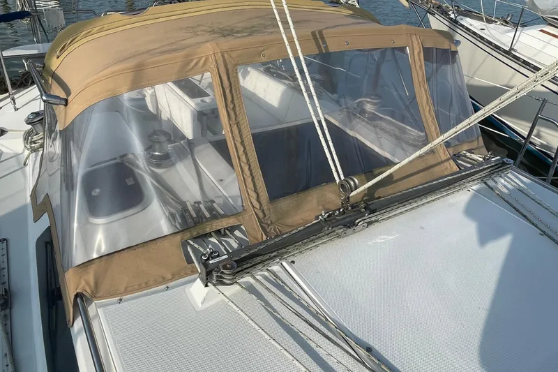 Slide: The Image of 1995 Catalina 36 MkII sailboat with tan cockpit cover and visible rigging. - 6