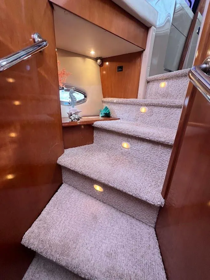 Slide: The Image of Interior stairs of 2006 Carver Voyager Sky Lounge yacht with carpet and wood finish. - 17