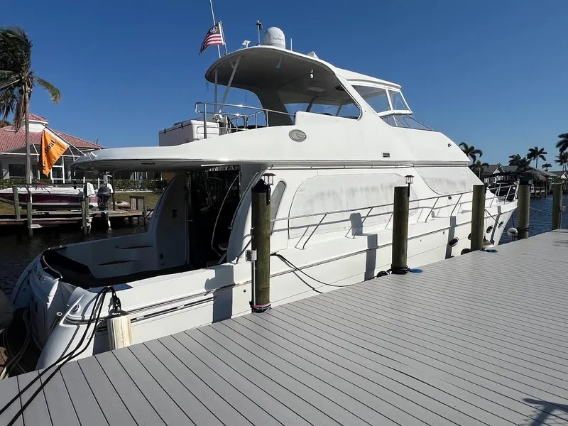 Slide: The Image of 2006 Carver Voyager Sky Lounge yacht docked under clear blue sky. - 2