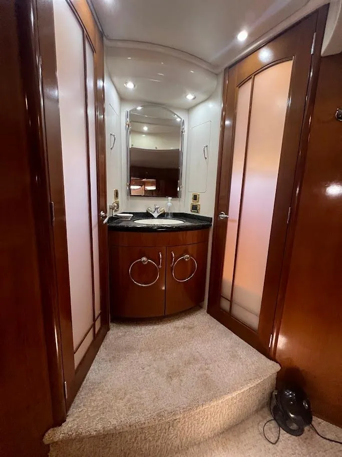 Slide: The Image of 2006 Carver Voyager Sky Lounge interior with wood cabinetry and carpeted flooring. - 20