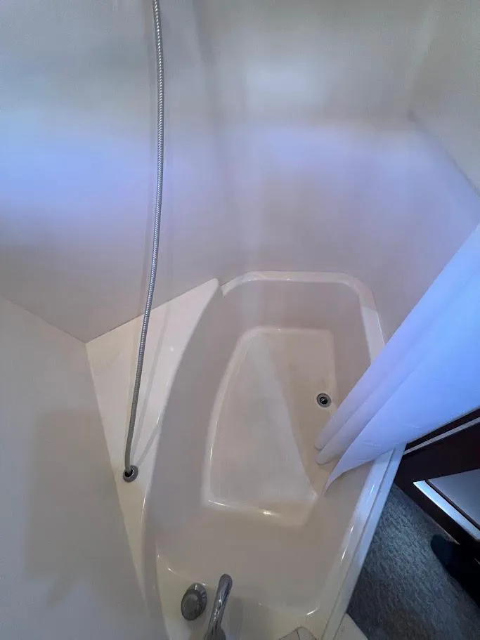 Slide: The Image of 2006 Carver Voyager Sky Lounge bathroom with shower and tub. - 22