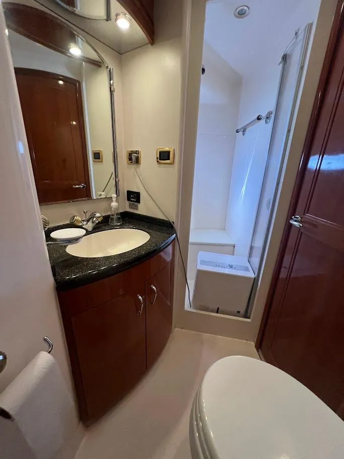 Slide: The Image of 2006 Carver Voyager Sky Lounge bathroom with modern fixtures and wood cabinetry. - 25