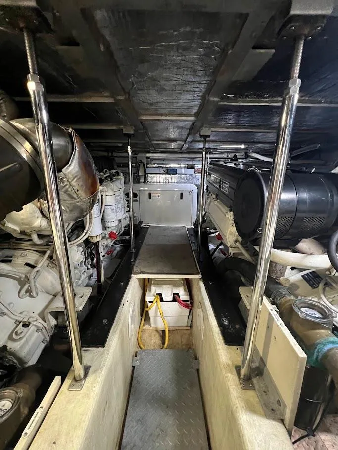Slide: The Image of Engine room of a 2006 Carver Voyager yacht, showcasing dual engines and mechanical components. - 38