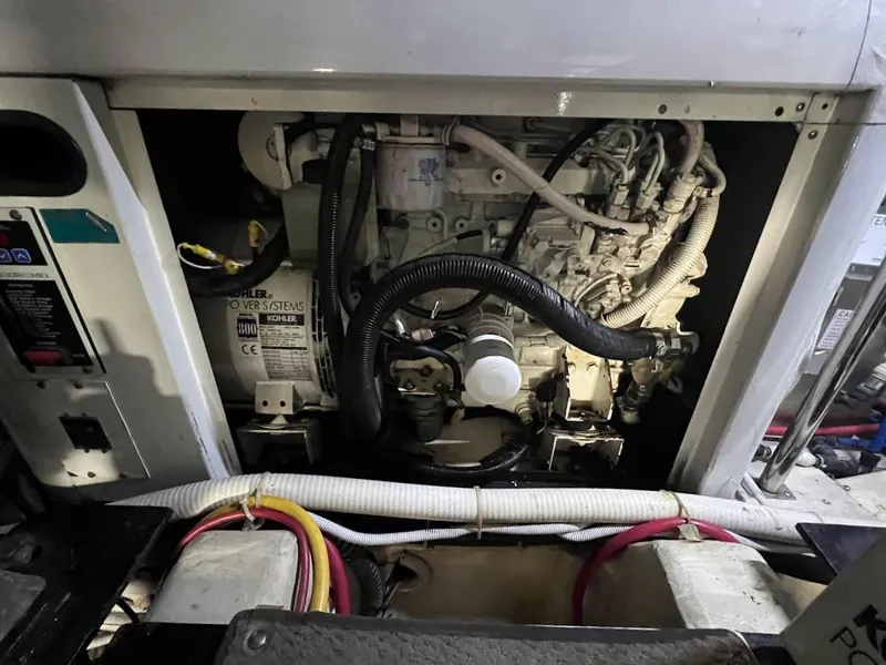 Slide: The Image of Engine compartment of a 2006 Carver Voyager boat, showcasing mechanical components and wiring. - 46