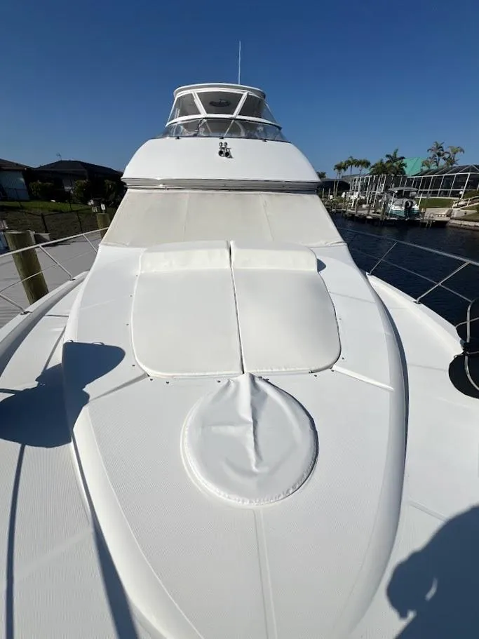 Slide: The Image of 2006 Carver Voyager yacht deck with sleek design and waterfront view. - 49