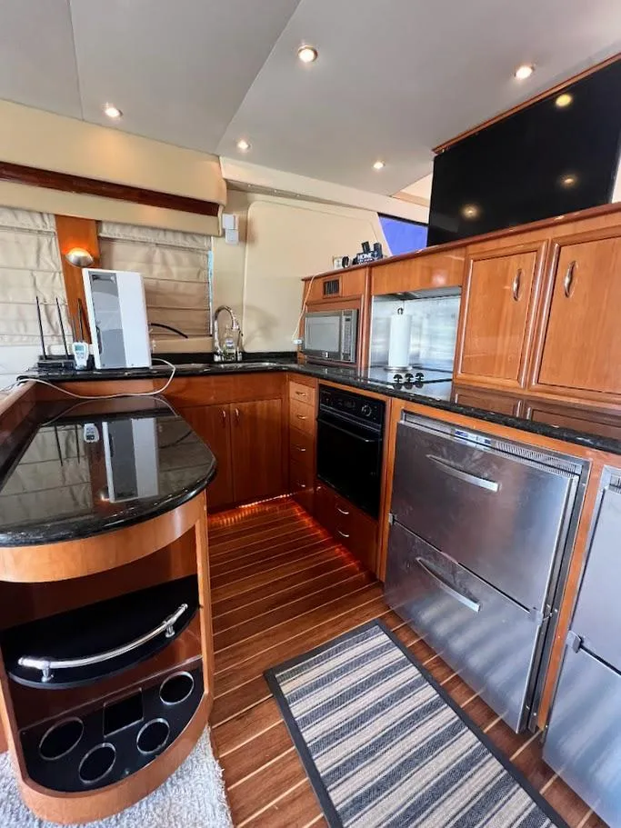 Slide: The Image of 2006 Carver Voyager Sky Lounge kitchen with modern appliances and sleek wooden cabinetry. - 8