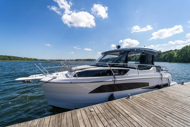 Slide: The Image of Modern Nautic 880 boat docked on a sunny day, 2025 model. - 5