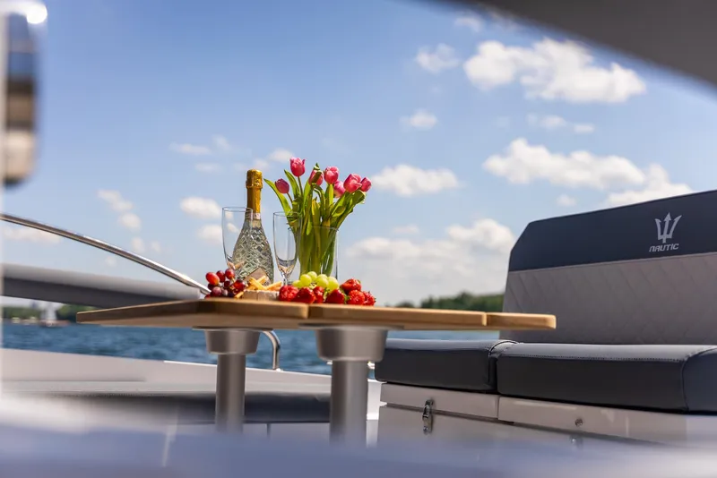 Slide: The Image of Luxury Nautic 880 yacht with champagne, flowers, and fruit on deck, 2025 model. - 9