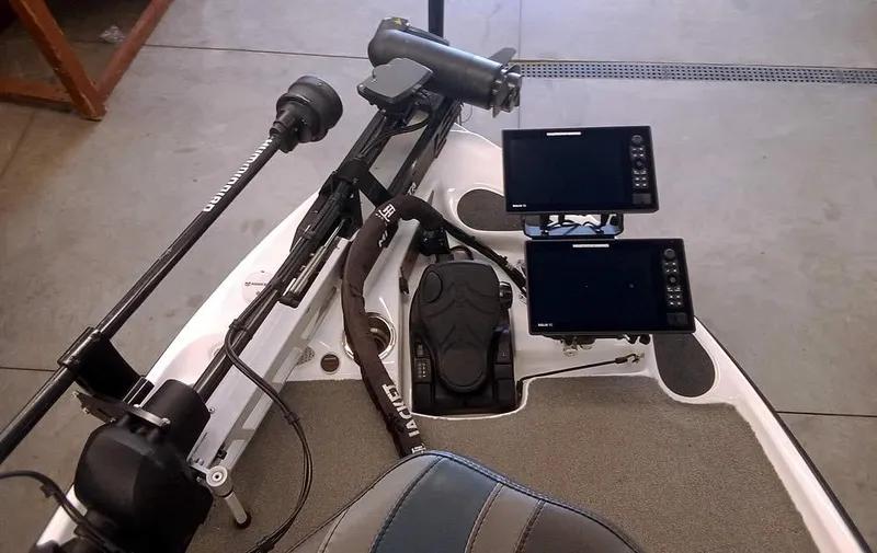 Slide: The Image of 2020 Bass Cat Puma FTD boat cockpit with dual fish finders and trolling motor. - 13