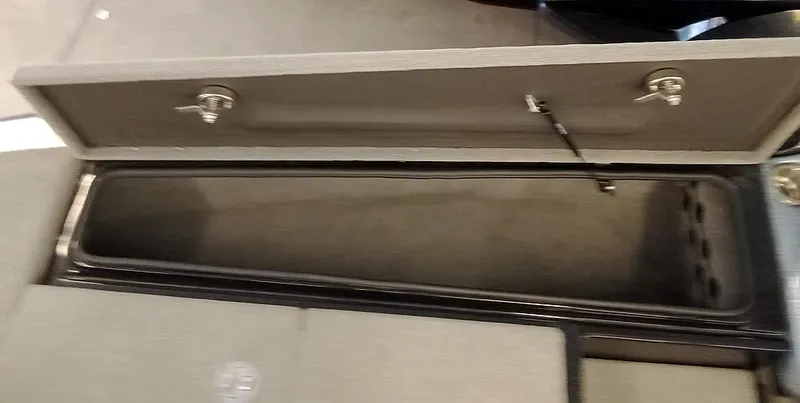 Slide: The Image of Open storage compartment in a 2020 Bass Cat Puma FTD boat. - 16