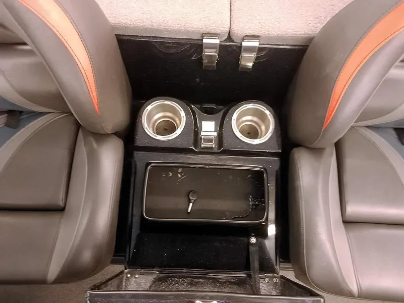 Slide: The Image of 2020 Bass Cat Puma FTD interior with cup holders and storage compartment. - 21