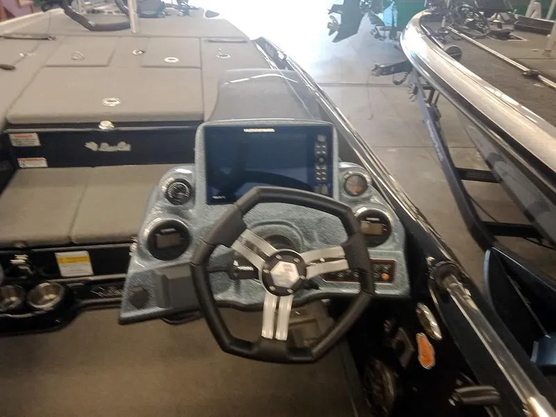 Slide: The Image of 2020 Bass Cat Puma FTD boat dashboard with steering wheel and control panel. - 24