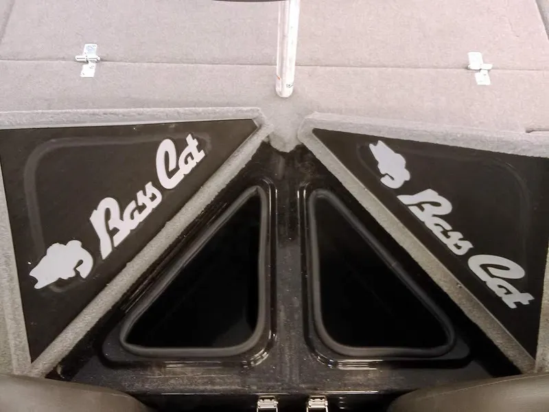 Slide: The Image of 2020 Bass Cat Puma FTD boat storage compartments with logo, featuring carpeted lids. - 26