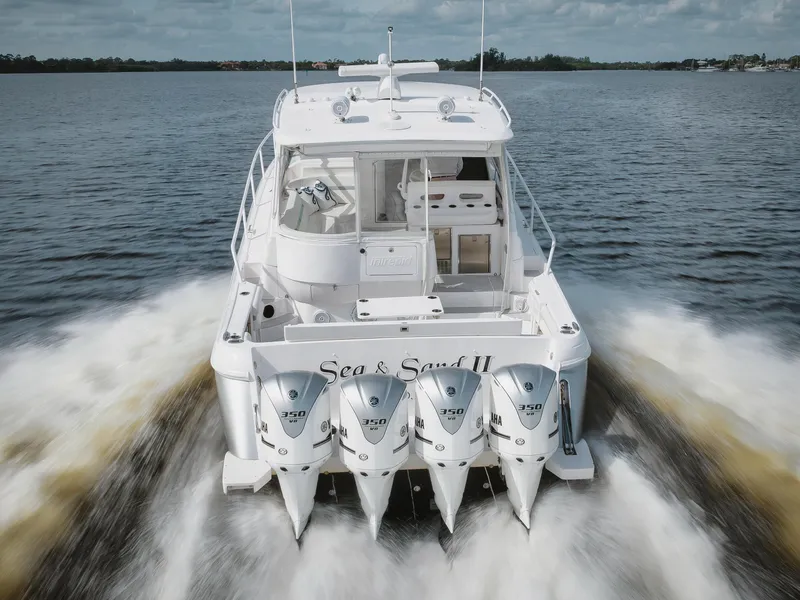 Slide: The Image of 2018 Intrepid 475 Sport Yacht cruising on open water, rear view with four engines. - 11