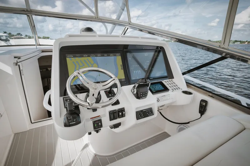 Slide: The Image of 2018 Intrepid 475 Sport Yacht helm with advanced navigation systems and sleek design. - 20
