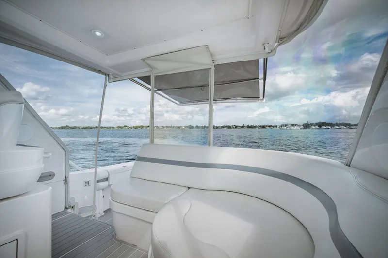 Slide: The Image of Intrepid 475 Sport Yacht 2018 interior with seating, overlooking serene water view. - 24