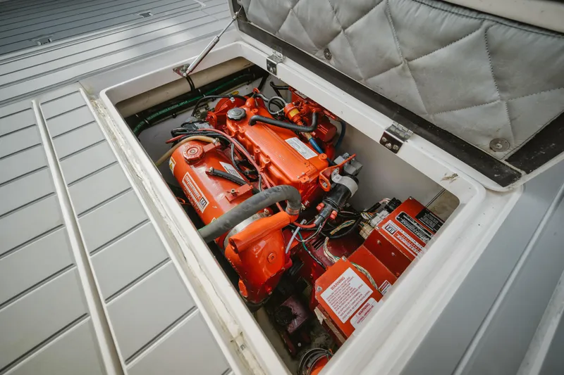 Slide: The Image of Engine compartment of a 2018 Intrepid 475 Sport Yacht, showcasing vibrant orange machinery. - 33