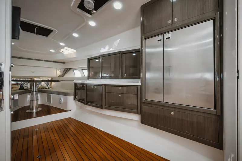 Slide: The Image of Luxurious interior of 2018 Intrepid 475 Sport Yacht with sleek cabinetry and wooden flooring. - 40
