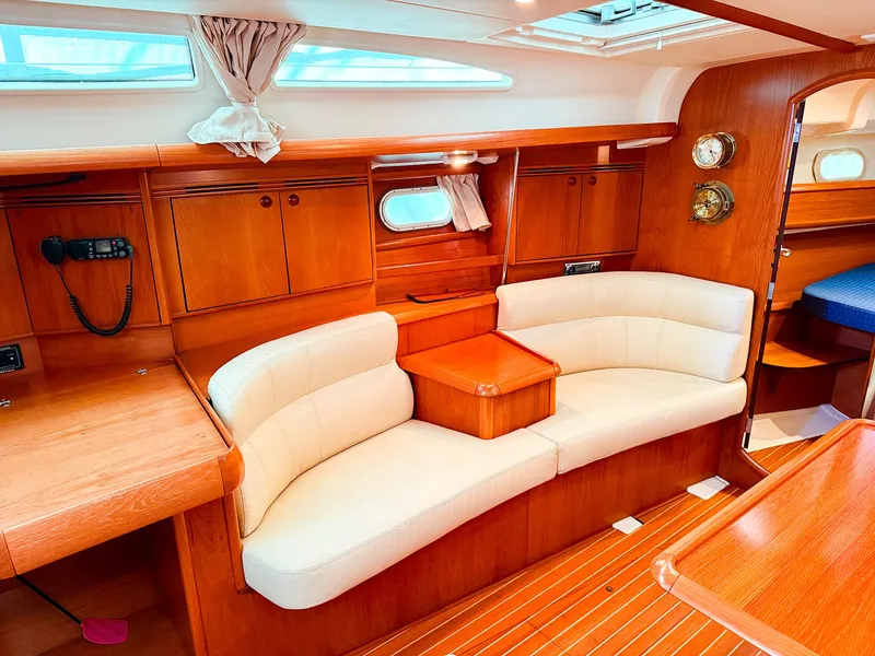 Slide: The Image of Interior of 2005 Jeanneau 40.3 yacht with elegant wood and cream seating. - 14
