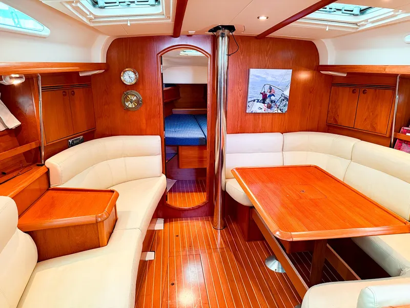 Slide: The Image of Interior of 2005 Jeanneau 40.3 sailboat with wood finish and cozy seating area. - 16